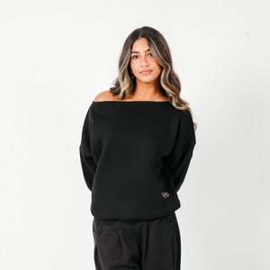 Woman wearing a black oversized sweatshirt on a white background
